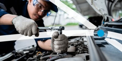 Mechanic fixing car engine in a neighborhood
