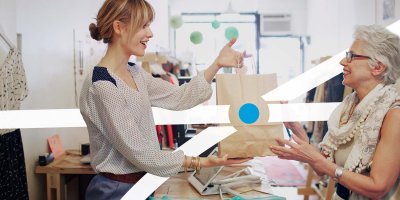 Woman turning 65 talking with women at store