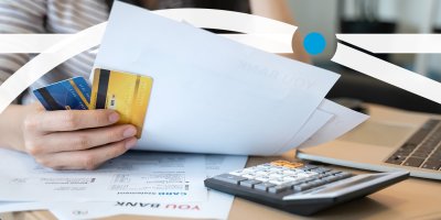 Woman holding credit card bills