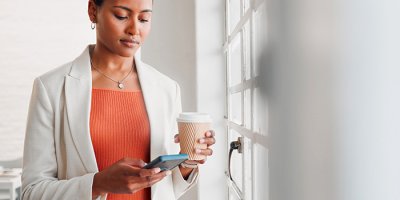 Professional woman checking email on mobile phone