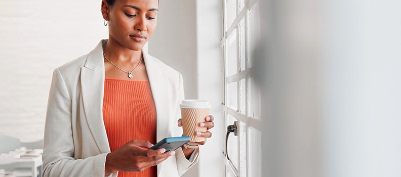 Professional woman checking email on mobile phone