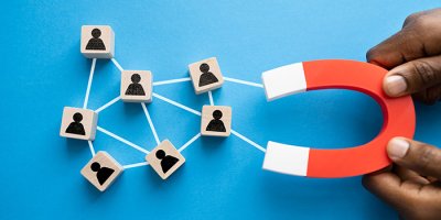 Man holding magnet attracting leading